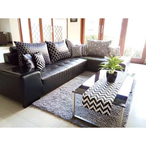 a living room with a black couch and a coffee table.