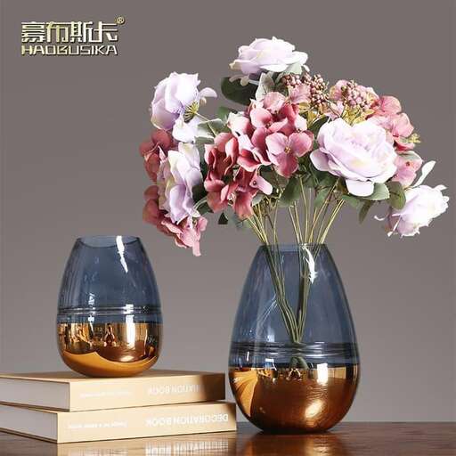 a vase with flowers on a stack of books.