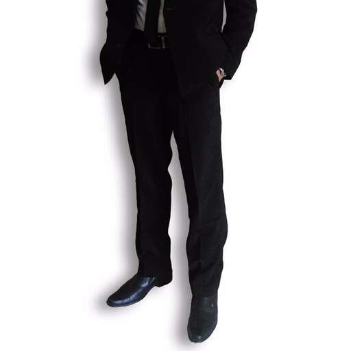 a man in a suit and tie standing against a white background.