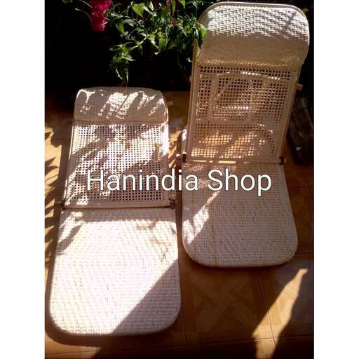 a wicker chair sitting on top of a wooden floor.