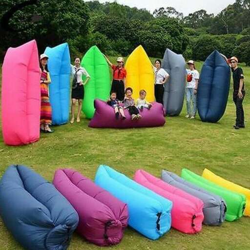 a group of people standing around inflatable boats.