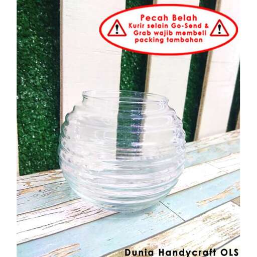 a glass bowl with a plant in it.