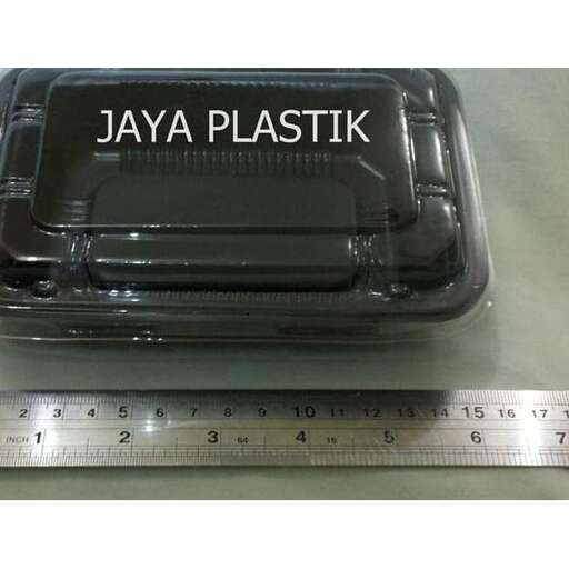 a plastic container with a ruler and a measuring tape.