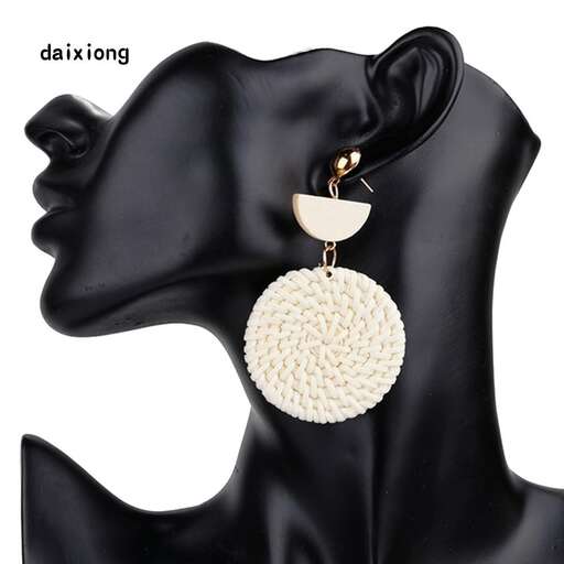 a black leather bag with a pendant and a round ball in the center.