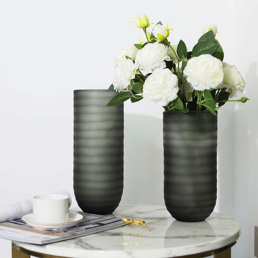 a black and white vase with flowers in it.