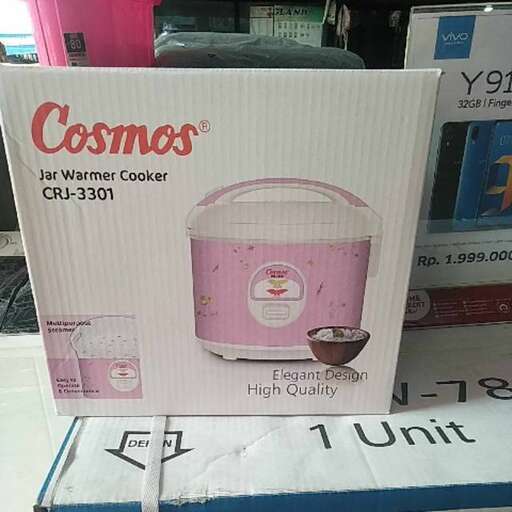 a pink ice cream maker sitting on a table.