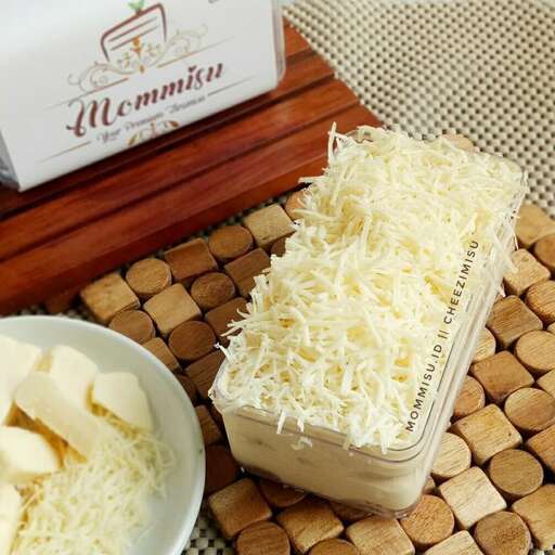 a bowl of cheese next to a bowl of cheese.