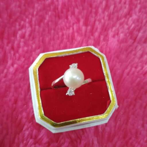a pearl ring in a red box