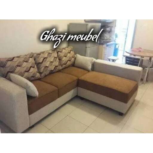 a couch with a pillow on it in a living room.