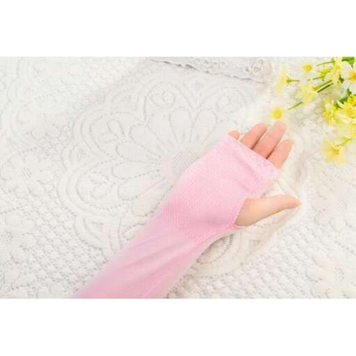 hand in a pink glove laying on a white blanket
