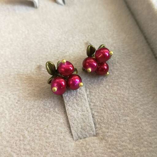 pink glass beads in a silver plated flower brooch.