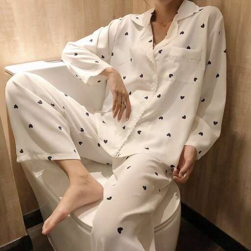 a woman sitting on a toilet in a room.