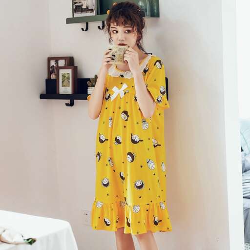 yellow dress with a cute little cat print in the background