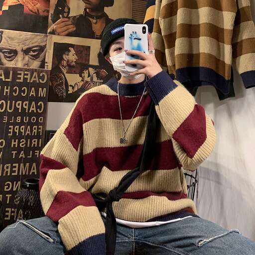 a man sitting in a chair holding a cell phone.