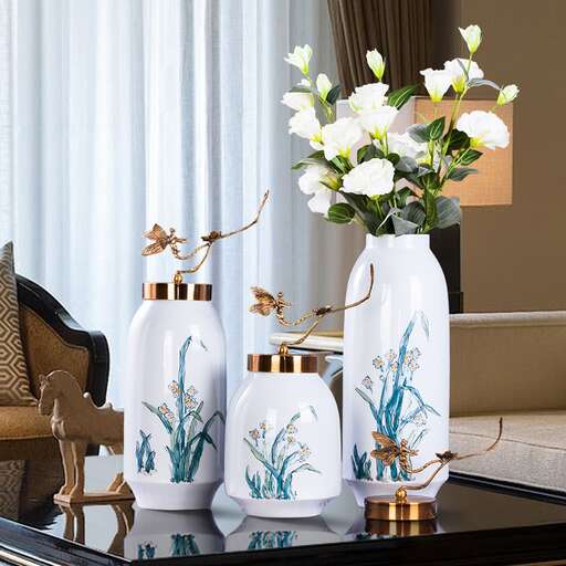 a table with vases on it and a vase with flowers in it.