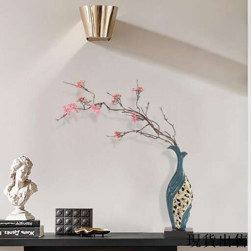 a vase with pink flowers on a black table