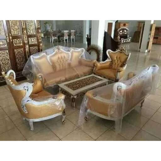 a living room with a couch and chairs.