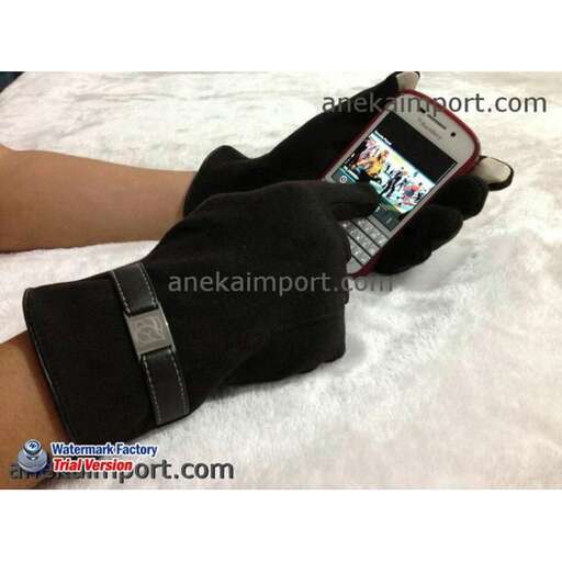 a person wearing a glove holding a cell phone.