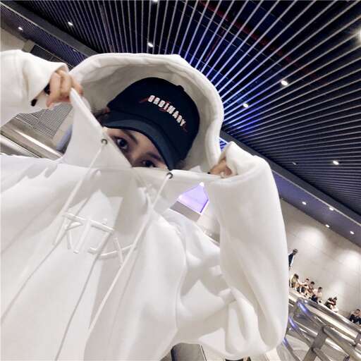 a girl in a white coat and a black hat.