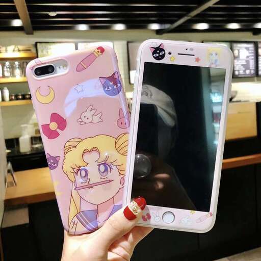 a person holding a pink phone in their hand.