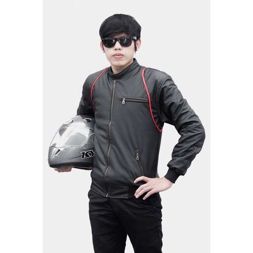 a man in a leather jacket and sunglasses holding a helmet.