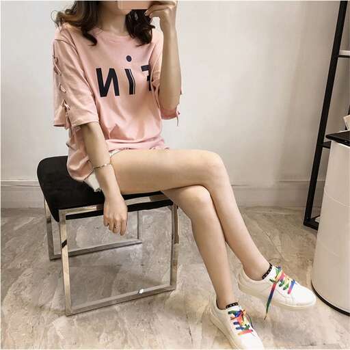 a girl in a pink shirt and sneakers
