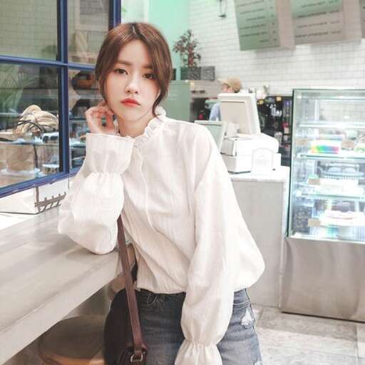 a woman standing in front of a counter.