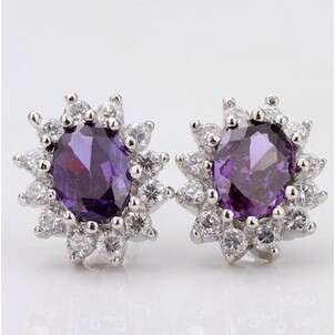a pair of 18k yellow and purple sapphire earrings