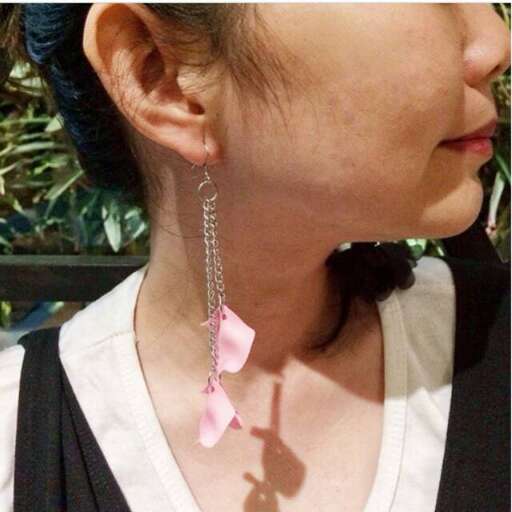person wearing a pink bow on her ear