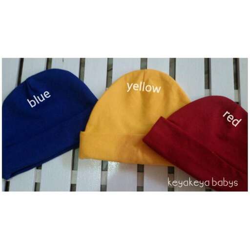 a yellow and red cap with a blue logo.