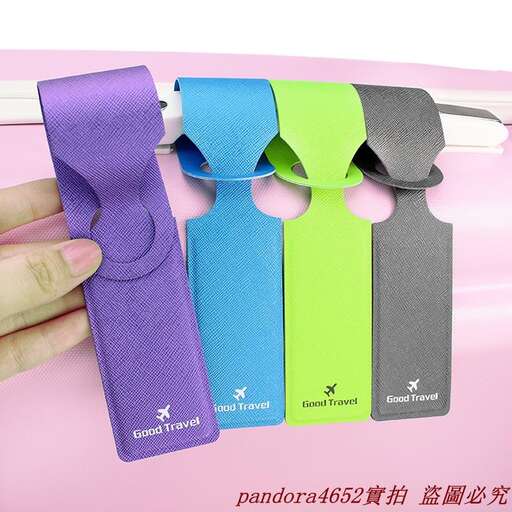 a hand holding a purple ribbon and a black and green bag.