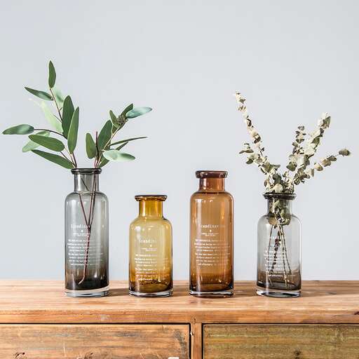 a collection of glass bottles and vases.