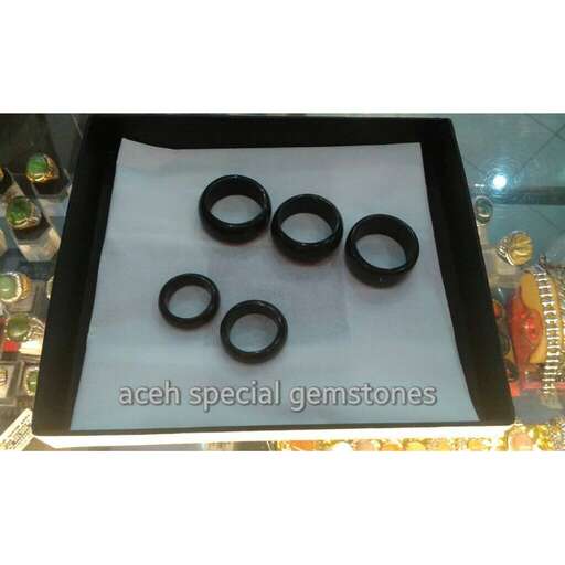 a black tray with three rings on it.