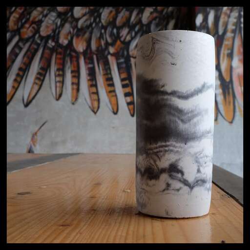 a paper towel roll with a bird painted on it.