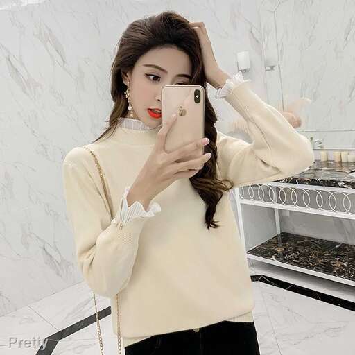 a woman holding a cell phone in front of her face.