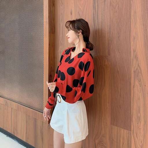 a girl in a red and black top and white shorts