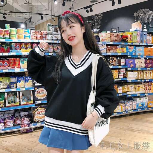 a girl in a black and white sweater and a white purse