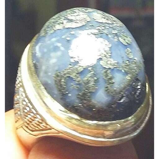 a ring with a blue stone in it.