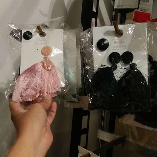 a person holding a small doll in a plastic bag.