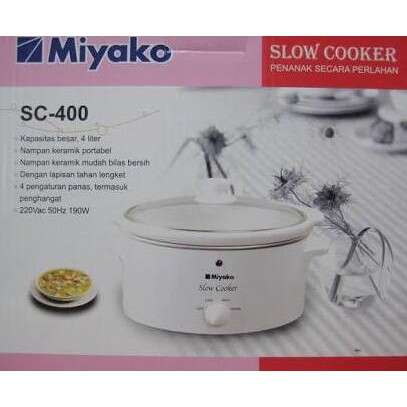 a small white crock pot with a lid on it.
