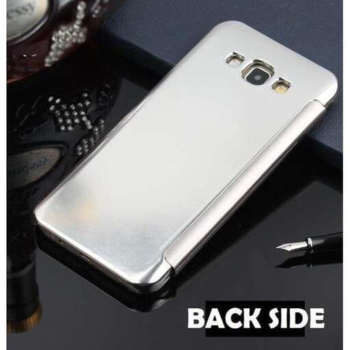 a silver cell phone sitting on a table.