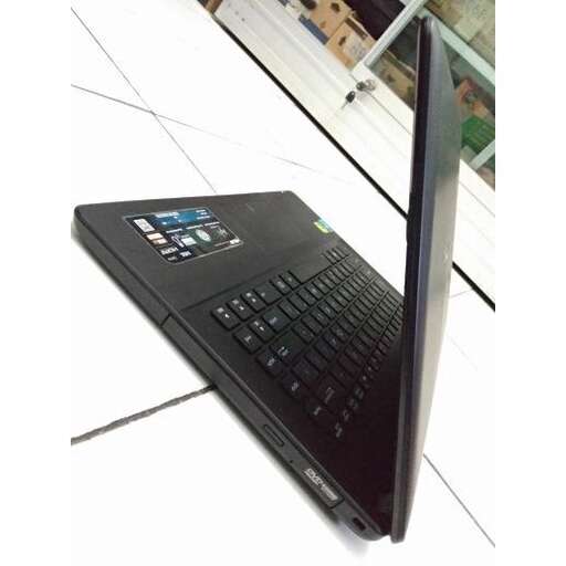 a black laptop computer sitting on a white surface.