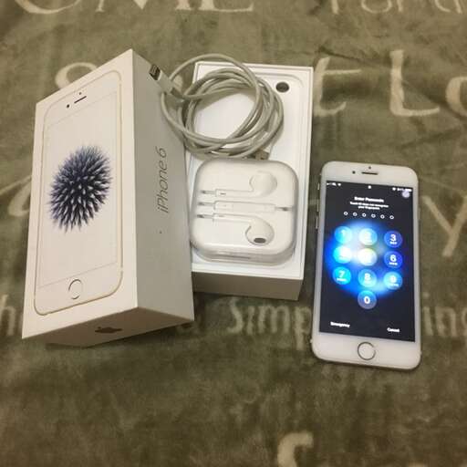 an iphone and a charger sitting next to an iphone.