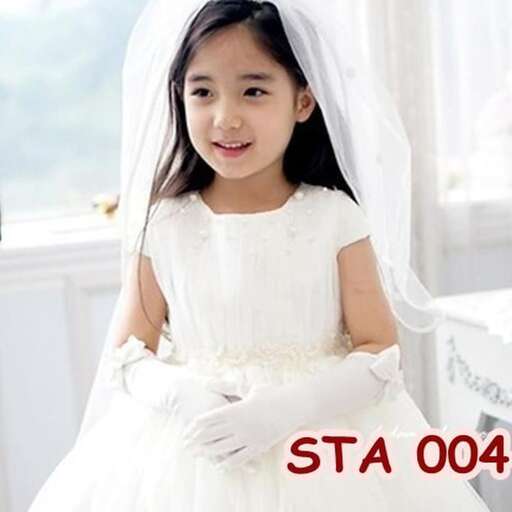 a young girl in a white dress is posing for a picture.