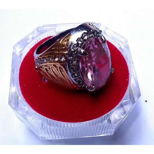 a ring made of sterling silver with a pink stone in the middle.