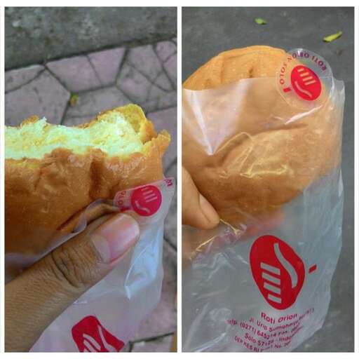 a person holding a sandwich in their hand.