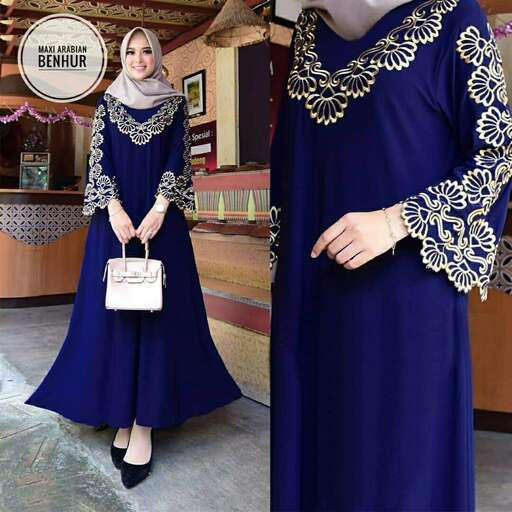 person is a beautiful royal blue dress with a gold embroidery.