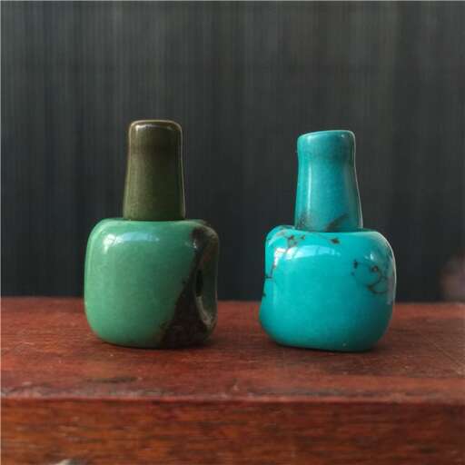 two small vases on a wooden table.