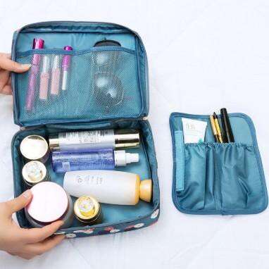 a woman's hands are holding a bag of cosmetics.