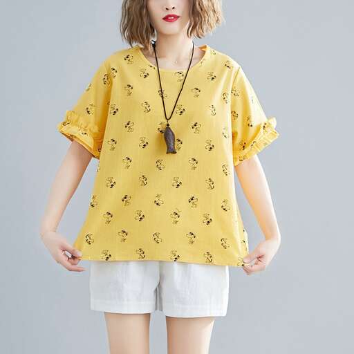 a yellow top with a black necklace